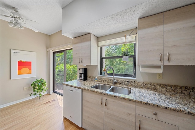 1612 Starling Dr Unit 101, Sarasota, FL 34231 - kitchen featuring light brown cabinetry, light wood-type flooring, dishwasher, and a sink