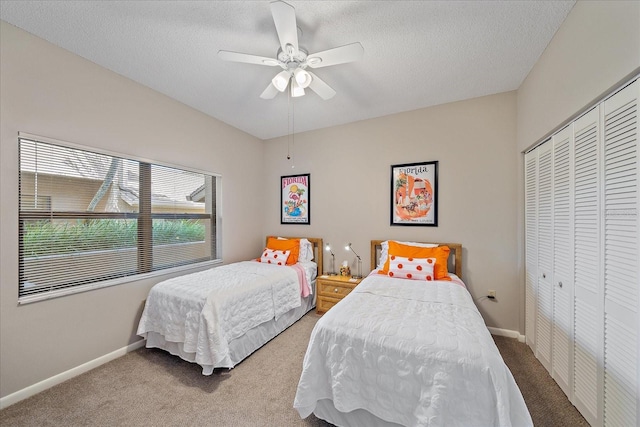 1612 Starling Dr Unit 101, Sarasota, FL 34231 - carpeted bedroom featuring a textured ceiling, a closet, ceiling fan, and baseboards