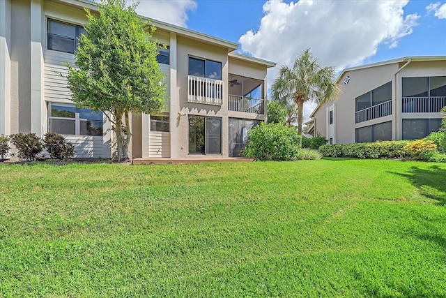 1612 Starling Dr Unit 101, Sarasota, FL 34231 - back of house with stucco siding and a lawn