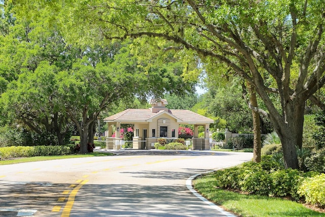 1612 Starling Dr Unit 101, Sarasota, FL 34231 - view of front of property featuring a tiled roof and curved driveway