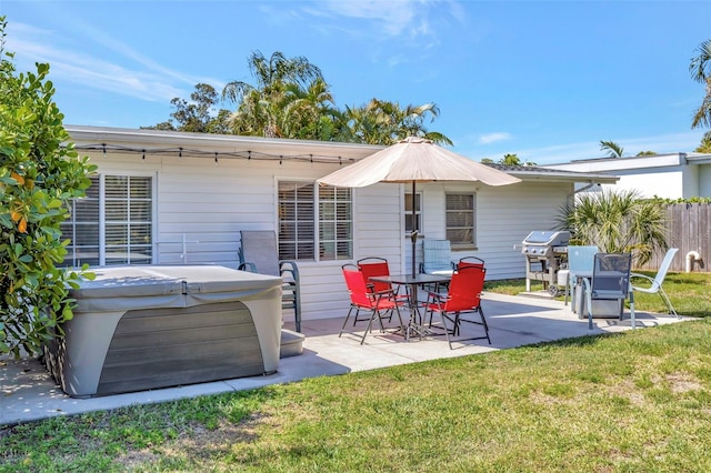 2307 Valencia Dr, Sarasota, FL 34239 - rear view of house featuring fence, a yard, a hot tub, and a patio