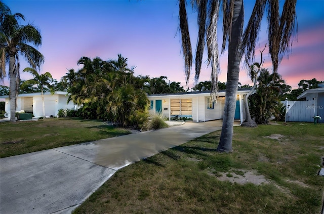 2307 Valencia Dr, Sarasota, FL 34239 - view of front of house with fence, driveway, and a yard