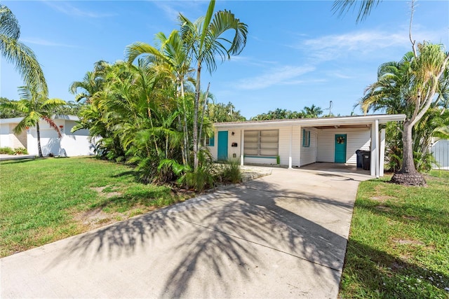 2307 Valencia Dr, Sarasota, FL 34239 - view of front facade with driveway, a front lawn, and an attached carport