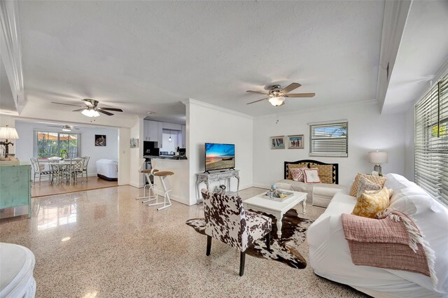 2307 Valencia Dr, Sarasota, FL 34239 - living area featuring a ceiling fan, baseboards, a textured ceiling, and speckled floor