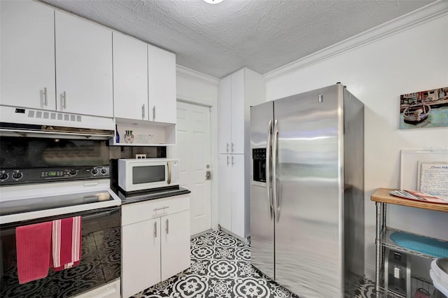 2307 Valencia Dr, Sarasota, FL 34239 - kitchen with range with electric stovetop, under cabinet range hood, crown molding, white microwave, and stainless steel fridge