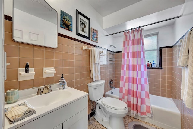 2307 Valencia Dr, Sarasota, FL 34239 - bathroom with vanity, shower / tub combo with curtain, tile walls, speckled floor, and toilet