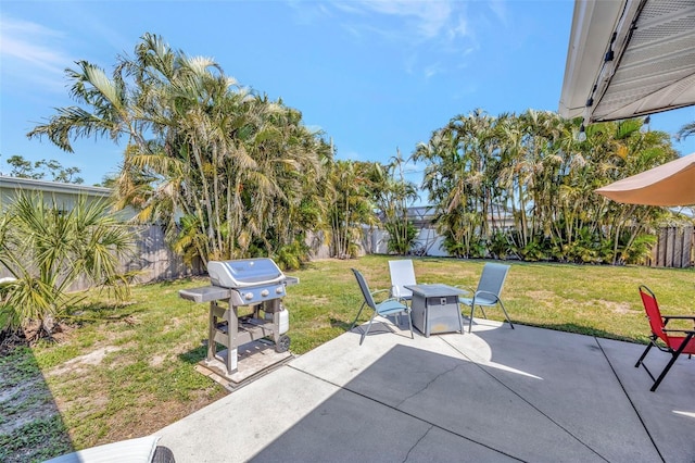 2307 Valencia Dr, Sarasota, FL 34239 - view of patio / terrace featuring grilling area, a fenced backyard, and an outdoor fire pit