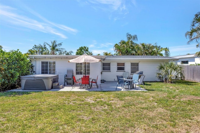 2307 Valencia Dr, Sarasota, FL 34239 - rear view of property featuring a yard, a hot tub, a patio, and fence