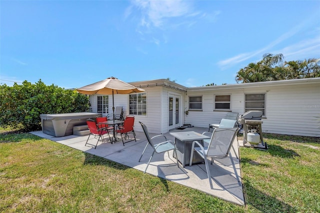 2307 Valencia Dr, Sarasota, FL 34239 - rear view of house with a patio area, a lawn, french doors, and a hot tub