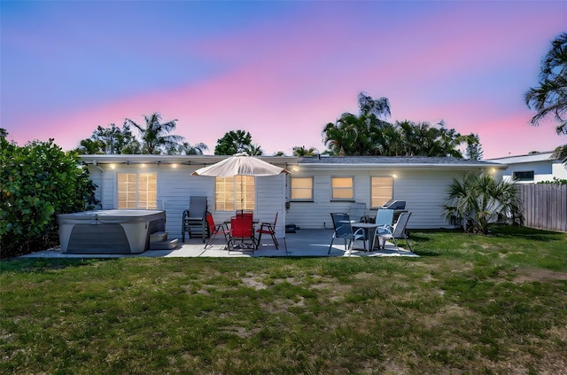 2307 Valencia Dr, Sarasota, FL 34239 - rear view of house featuring a hot tub and a patio