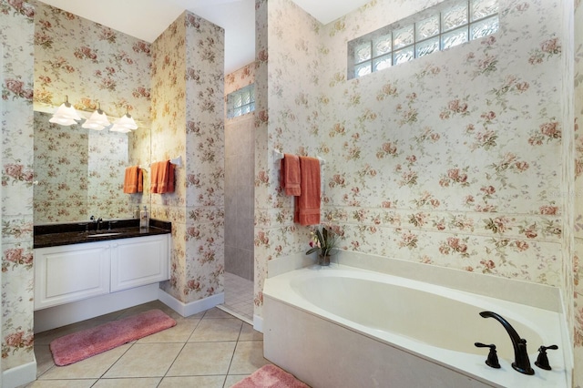 8715 52nd Ave E, Bradenton, FL 34211 - full bath featuring a bath, tile patterned floors, vanity, a walk in shower, and wallpapered walls