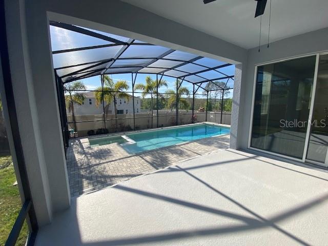 1142 Blarney St, Minneola, FL 34715 - view of pool with a patio area, a pool with connected hot tub, a lanai, and ceiling fan