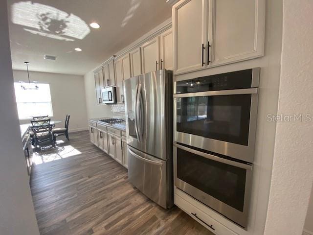 1142 Blarney St, Minneola, FL 34715 - kitchen with dark wood-style flooring, recessed lighting, visible vents, and stainless steel appliances