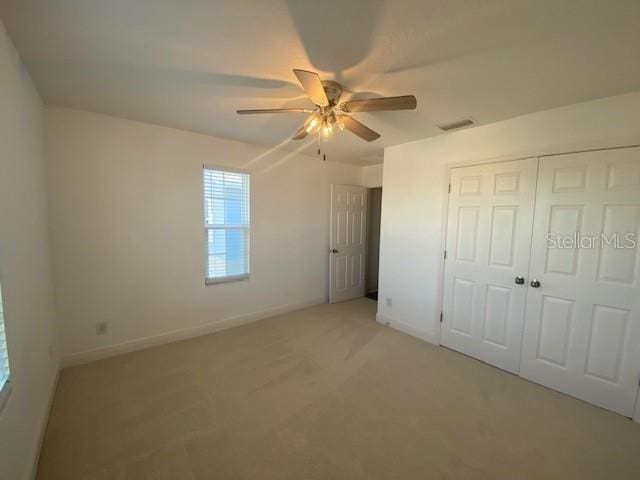 1142 Blarney St, Minneola, FL 34715 - unfurnished bedroom featuring light carpet, visible vents, a closet, and baseboards