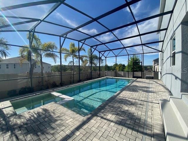 1142 Blarney St, Minneola, FL 34715 - view of swimming pool featuring a patio, a pool with connected hot tub, and glass enclosure