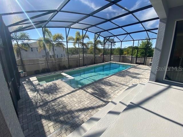 1142 Blarney St, Minneola, FL 34715 - view of pool with a patio, a pool with connected hot tub, and glass enclosure