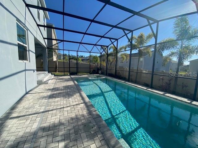 1142 Blarney St, Minneola, FL 34715 - outdoor pool with a patio and glass enclosure