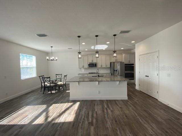 1142 Blarney St, Minneola, FL 34715 - kitchen with dark wood-style flooring, baseboards, recessed lighting, stainless steel appliances, and a sink
