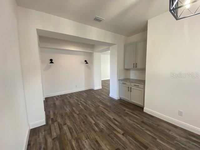 1142 Blarney St, Minneola, FL 34715 - interior space with dark wood-type flooring, baseboards, and visible vents