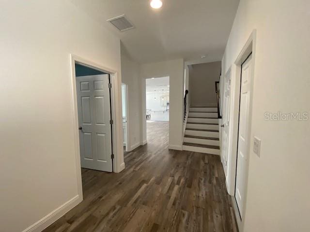 1142 Blarney St, Minneola, FL 34715 - hallway featuring dark wood-type flooring, baseboards, and stairs