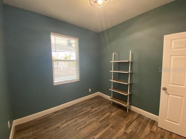 1142 Blarney St, Minneola, FL 34715 - empty room with dark wood-type flooring and baseboards