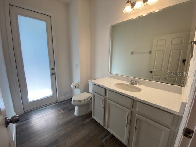 1142 Blarney St, Minneola, FL 34715 - bathroom with toilet, vanity, and wood finished floors