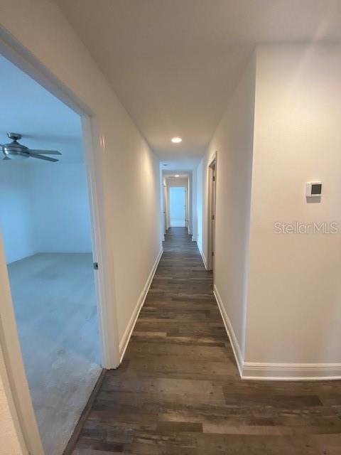 1142 Blarney St, Minneola, FL 34715 - hallway featuring baseboards, dark wood-style floors, and recessed lighting