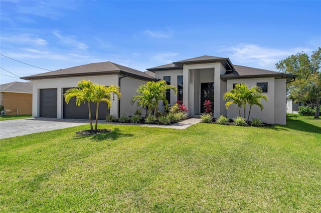 3724 SW 3rd St, Cape Coral, FL 33991 - prairie-style home with a front yard, decorative driveway, a garage, and stucco siding