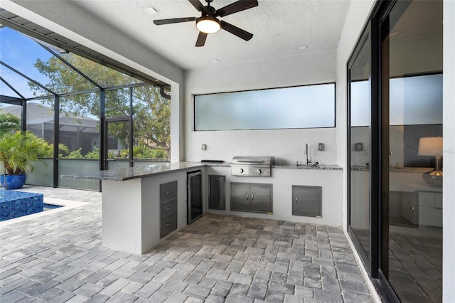 3724 SW 3rd St, Cape Coral, FL 33991 - view of patio with a grill, a ceiling fan, area for grilling, glass enclosure, and a sink