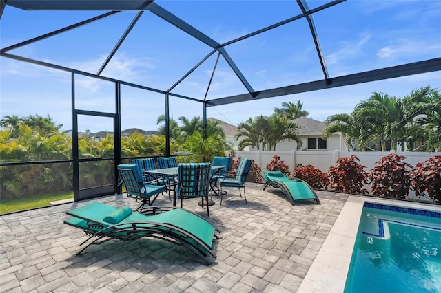 3724 SW 3rd St, Cape Coral, FL 33991 - view of patio / terrace featuring outdoor dining space, a fenced in pool, fence, and glass enclosure