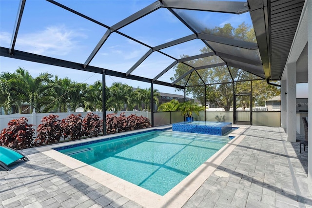 3724 SW 3rd St, Cape Coral, FL 33991 - view of swimming pool featuring a fenced backyard, a pool with connected hot tub, a patio, and glass enclosure