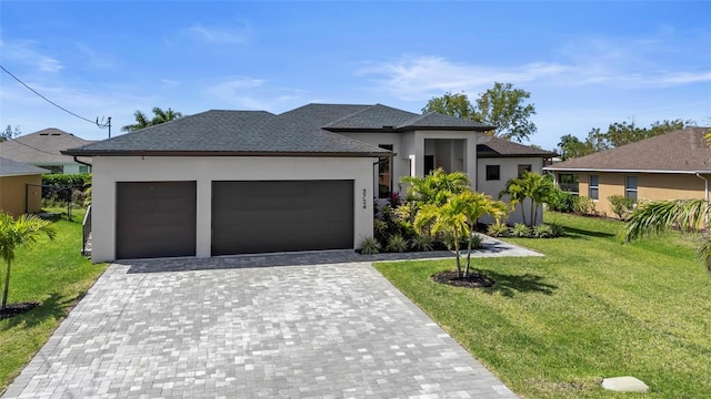 3724 SW 3rd St, Cape Coral, FL 33991 - prairie-style home with an attached garage, stucco siding, a front lawn, decorative driveway, and roof with shingles