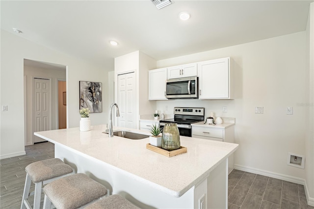 1073 Bristol St, Port Charlotte, FL 33952 - kitchen with appliances with stainless steel finishes, a sink, a kitchen breakfast bar, baseboards, and lofted ceiling
