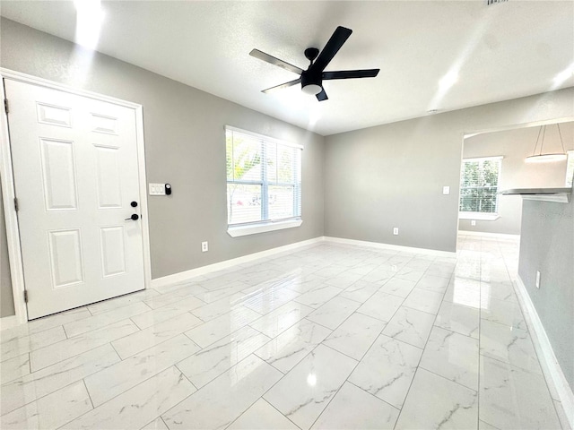 1142 Newhope Rd, Spring Hill, FL 34606 - spare room with marble finish floor, baseboards, and a ceiling fan