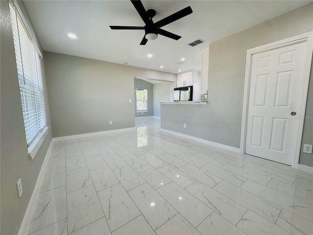 1142 Newhope Rd, Spring Hill, FL 34606 - unfurnished living room with marble finish floor, baseboards, visible vents, and ceiling fan