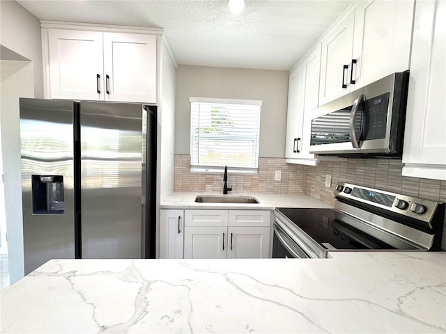 1142 Newhope Rd, Spring Hill, FL 34606 - kitchen with tasteful backsplash, stainless steel appliances, white cabinetry, and a sink