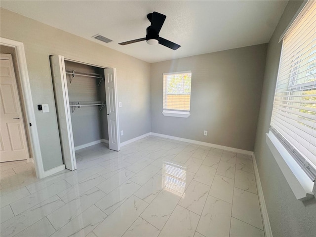 1142 Newhope Rd, Spring Hill, FL 34606 - unfurnished bedroom featuring a closet, marble finish floor, ceiling fan, baseboards, and visible vents