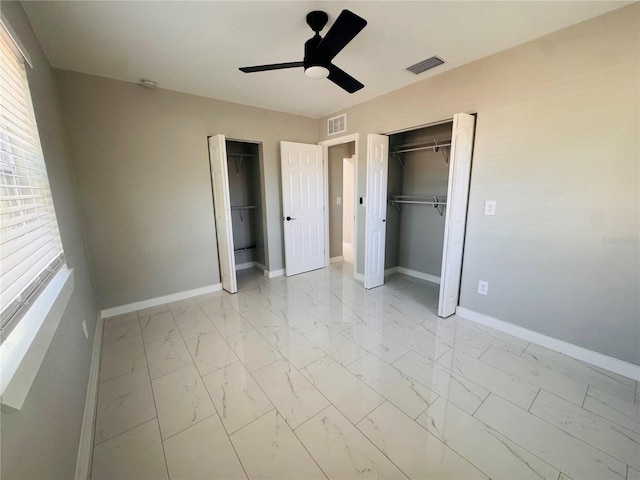 1142 Newhope Rd, Spring Hill, FL 34606 - unfurnished bedroom with visible vents, multiple closets, baseboards, and marble finish floor