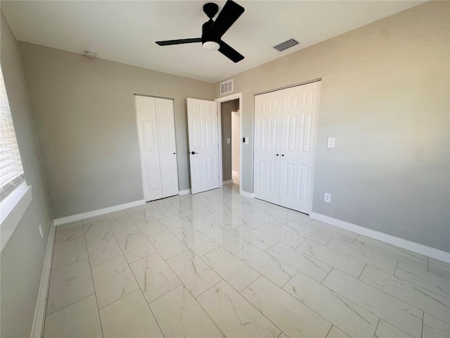 1142 Newhope Rd, Spring Hill, FL 34606 - unfurnished bedroom featuring visible vents, baseboards, marble finish floor, and two closets
