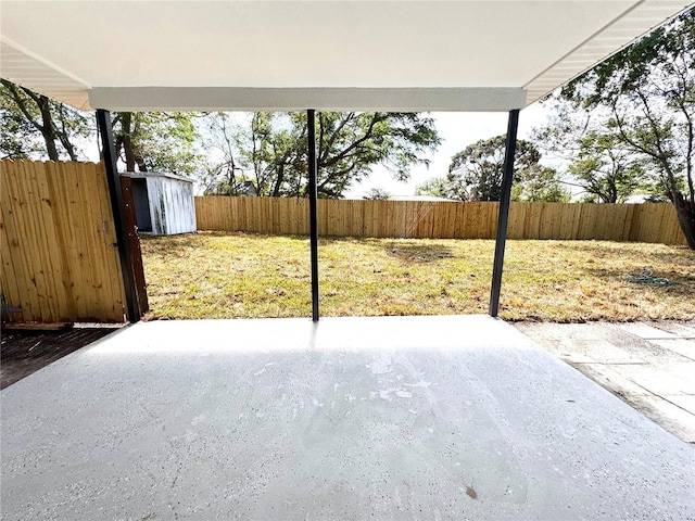 1142 Newhope Rd, Spring Hill, FL 34606 - view of patio / terrace with a fenced backyard, an outdoor structure, and a storage unit