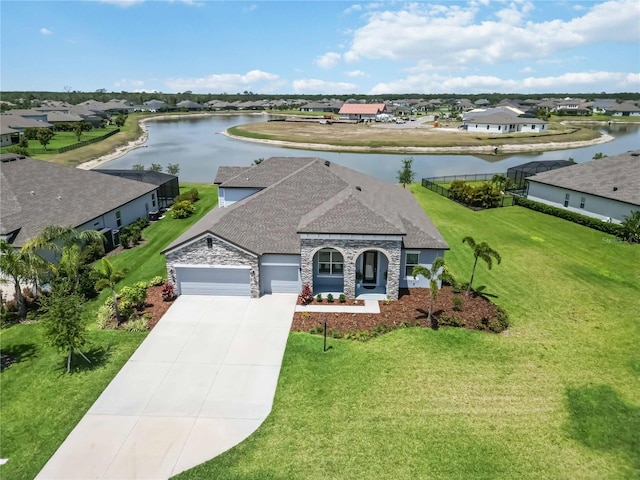 bird's eye view featuring a residential view and a water view