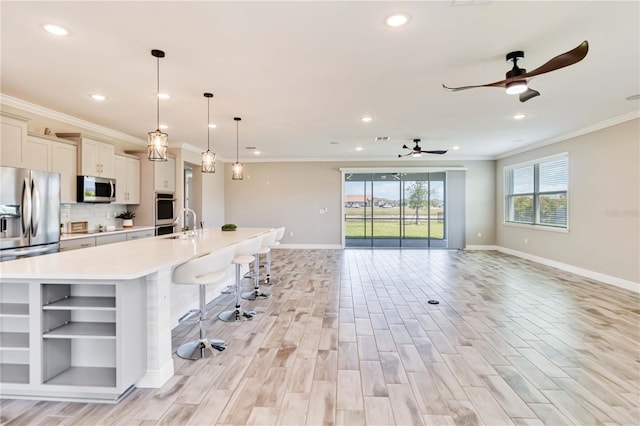 kitchen with open shelves, ceiling fan, stainless steel appliances, light countertops, and baseboards