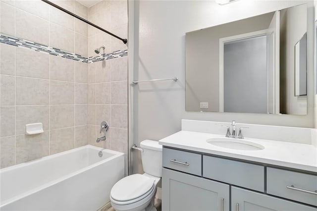 bathroom featuring toilet, vanity, and  shower combination