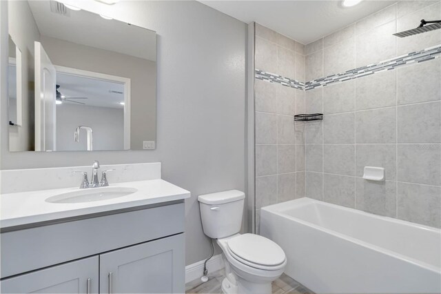 full bathroom with vanity, shower / bathtub combination, toilet, visible vents, and baseboards