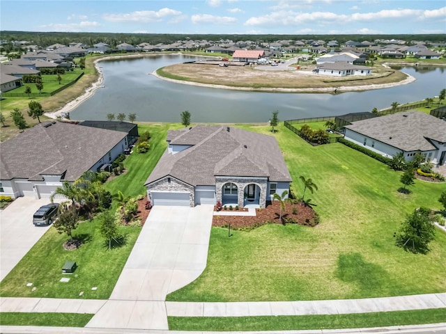 drone / aerial view with a residential view and a water view