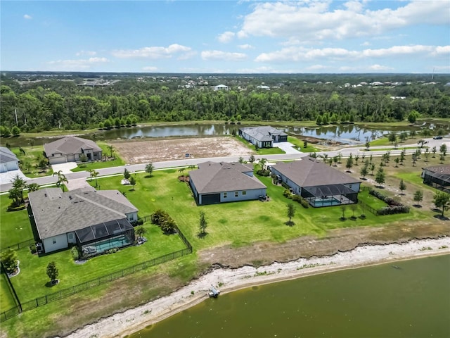 birds eye view of property featuring a water view and a forest view
