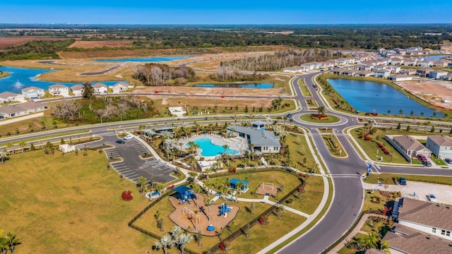 drone / aerial view featuring a residential view and a water view