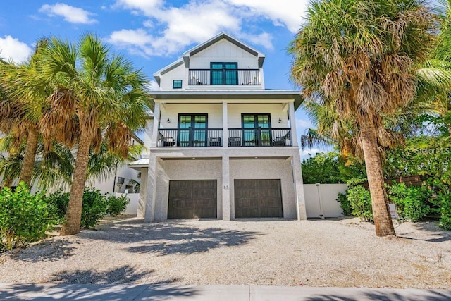 89 Avenida Messina, Sarasota, FL 34242 - coastal inspired home featuring a balcony, driveway, french doors, an attached garage, and fence