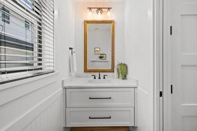 89 Avenida Messina, Sarasota, FL 34242 - bathroom featuring a wainscoted wall, vanity, and a decorative wall