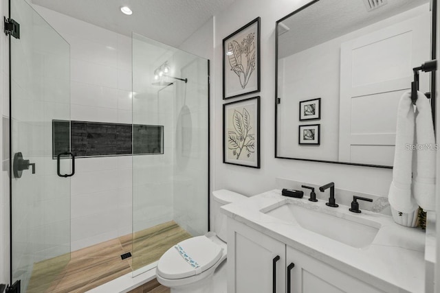 89 Avenida Messina, Sarasota, FL 34242 - full bath with a textured ceiling, toilet, recessed lighting, a shower stall, and vanity